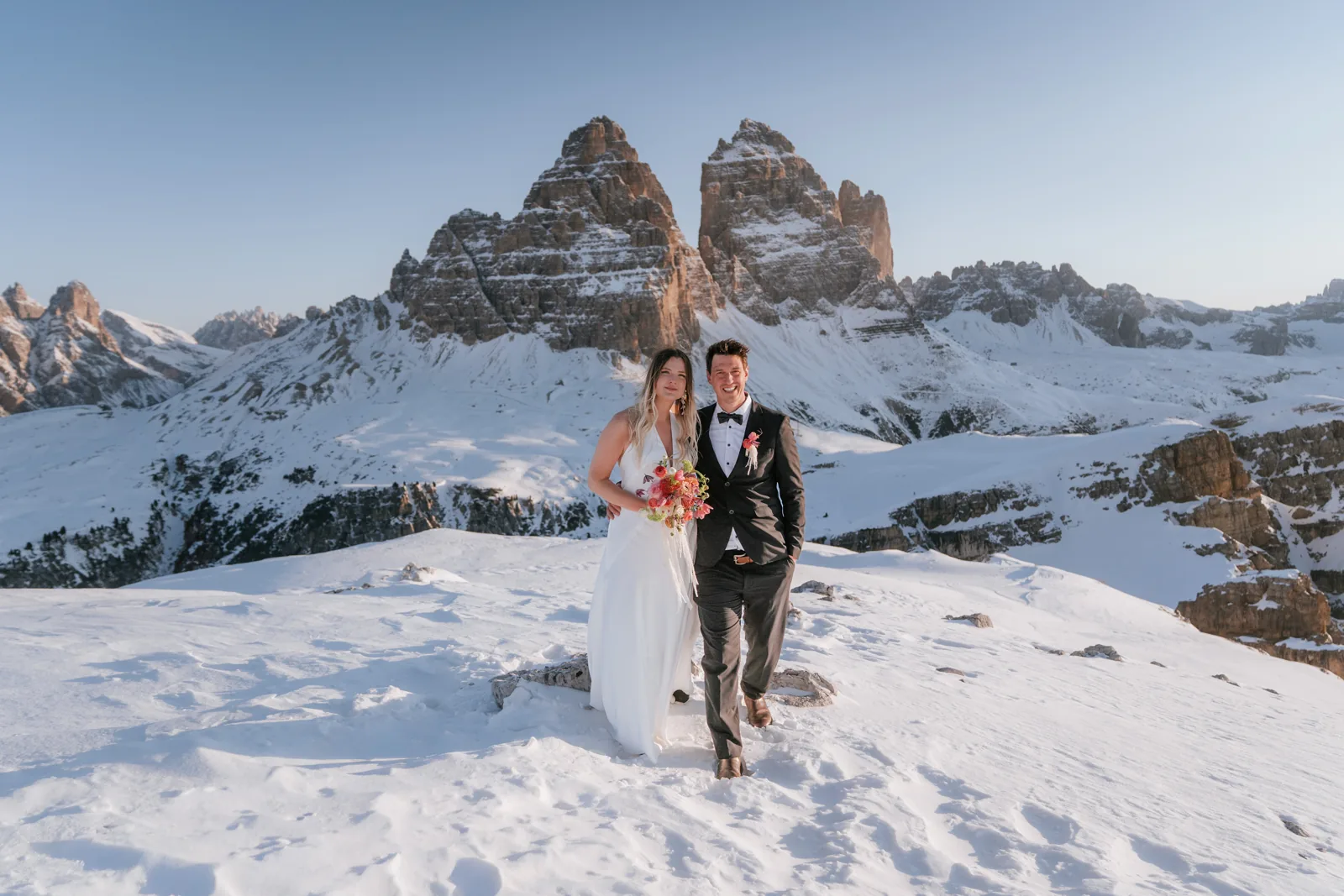The couple on a snowy plateau below the Tre Cime in full winter