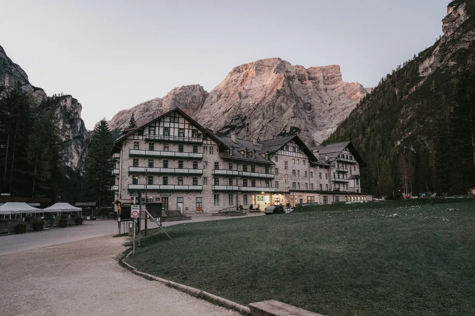The historic hotel at Lago di Braies as the peak behind catches dawn light