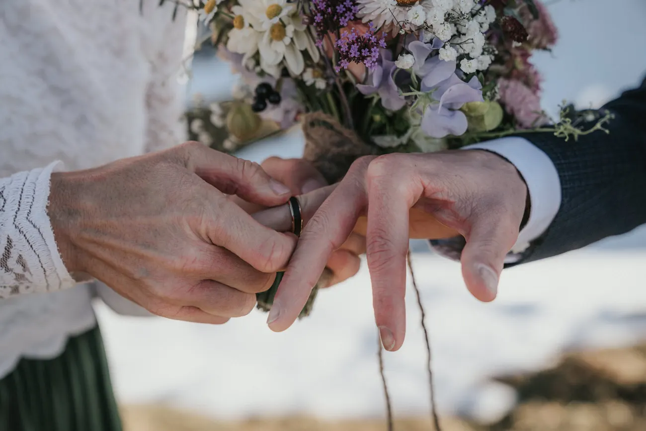 The exchange of rings with the valley falling away behind