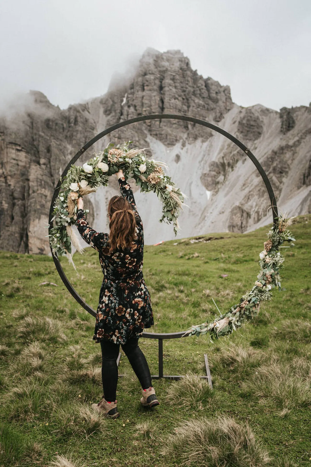 A floral arch set beside a Tyrolean lake for the vows