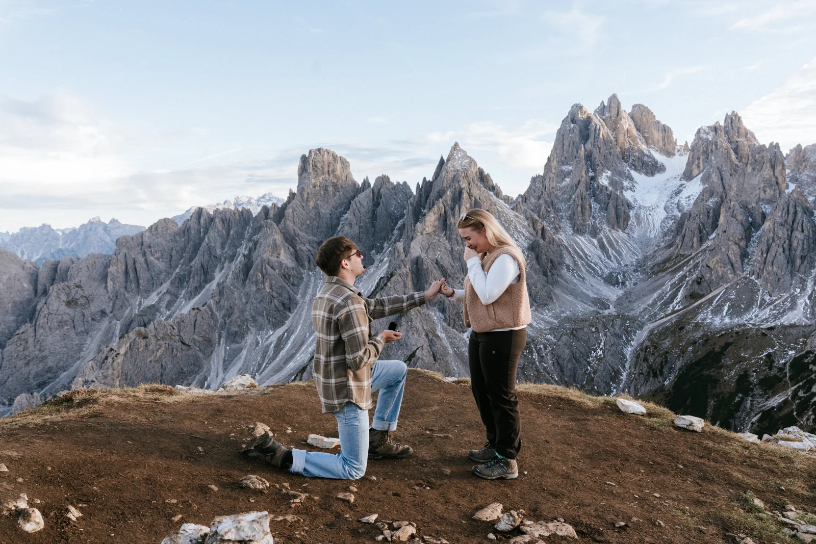 A partner kneeling to propose before the Dolomite spires
