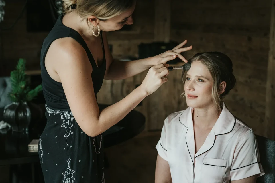 The make-up artist at work during the calm of getting ready