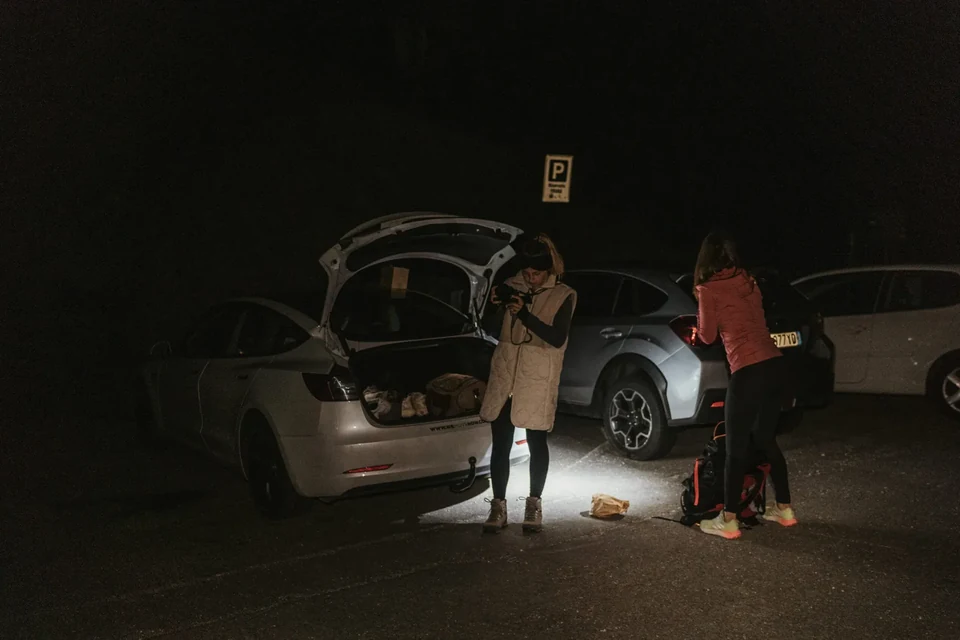 Gearing up at the trailhead car park in the dark before dawn