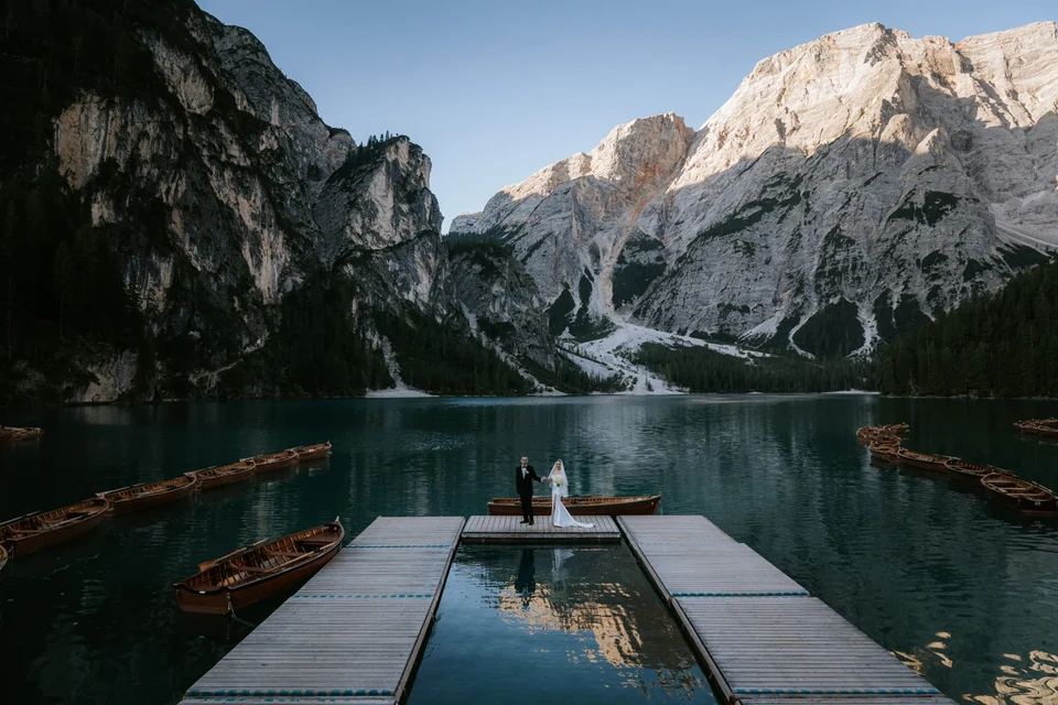 Dawn on the Lago di Braies jetty, the water mirror-still
